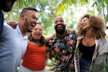 A group of diverse people laughing and smiling together. 