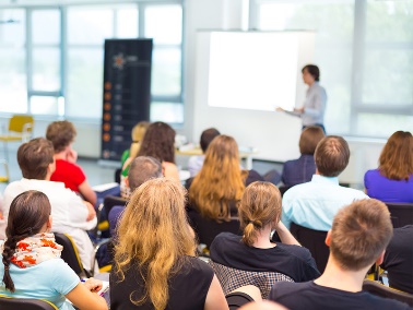 A group of people looking at a teacher.