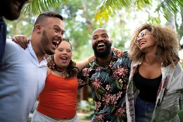 A group of diverse people laughing and smiling together.