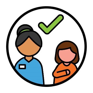 A support worker with a child. There is a tick above them.