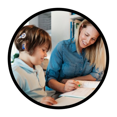 Someone supporting a child to read and write.