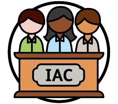 3 people sitting at a panel with 'IAC' on it.