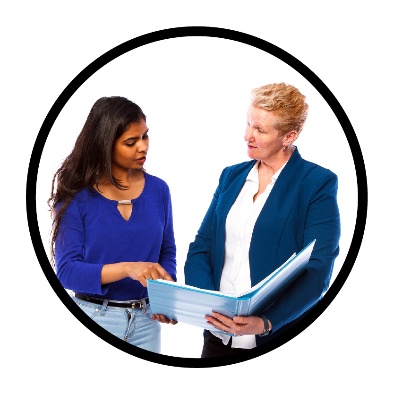 2 people looking at a folder together. One is pointing at the folder.