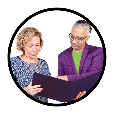 A Reference Group member looking at a document with an NDIA worker.