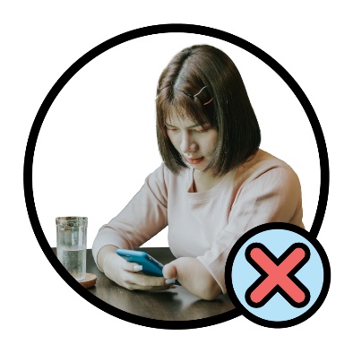 A participant looking at their phone. A cross is next to them.