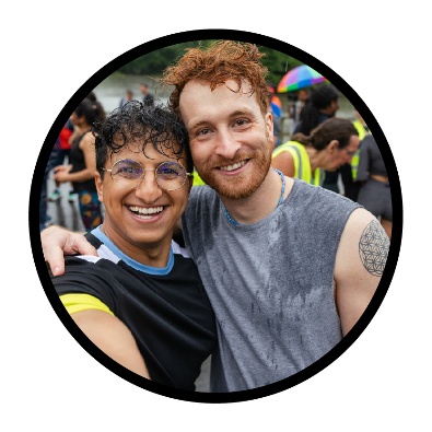 2 people standing closely and smiling.
