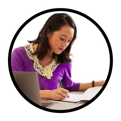 An NDIA worker writing on a document.