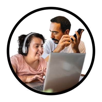 A person using a laptop next to a person making a phone call.