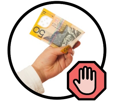 A hand holding 50 dollars next to a stop sign.