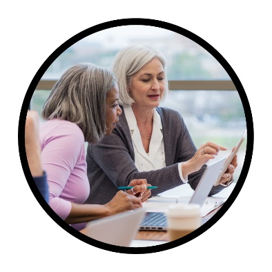 2 people looking over a document together.