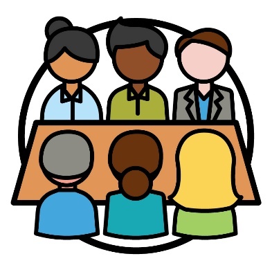 A group of people around a table. 
