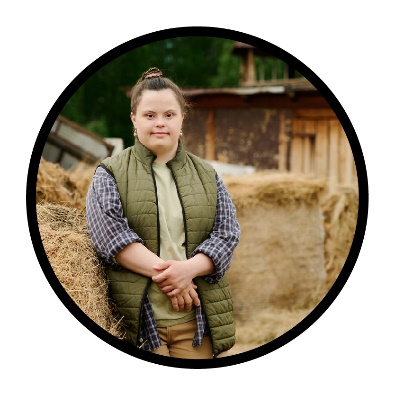 A person next to hay bales. 
