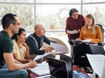 A group of people working on a document together.