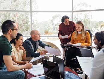 A large group of people working on a document together.