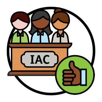 A group of people behind an 'IAC' lectern. There is a thumbs up next to them.