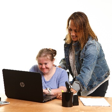 A person supporting a participant to use a computer.