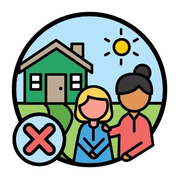 A child being supported by someone else in front of a house. Next to them is a cross.