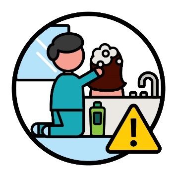 A support worker bathing a person with disability. Next to them is a problem icon.