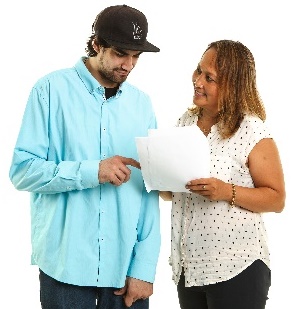 A man and a woman looking at a document together. 