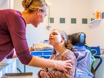 Someone supporting another person in a medical room.