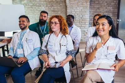 A group of health professionals taking notes in a meeting.