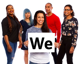 A group of people. There is a person at the front of the group, they are holding a card that says 'we'.