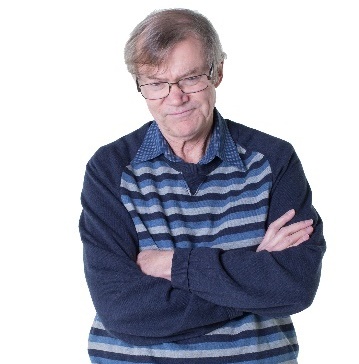 A man with his arms crossed. He looks unhappy.