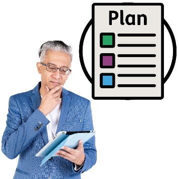 A person reading a document next to a plan document.