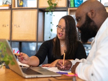 An NDIA worker learning from a person with disability.