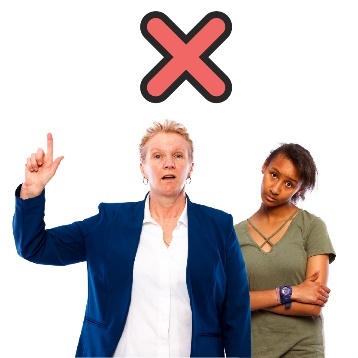 A person in a suit speaking, while a young person is behind them with their arms crossed. There is a cross above. 