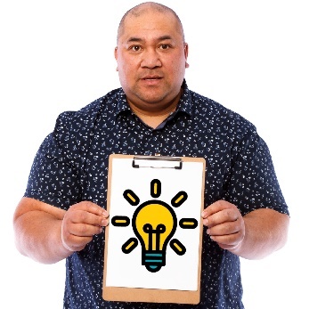 A person holding a document showing a lightbulb.