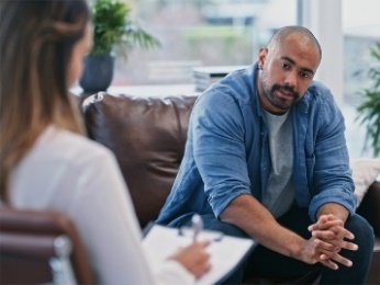 A person going to therapy with a counsellor.