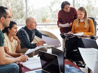 A group of people discussing a document