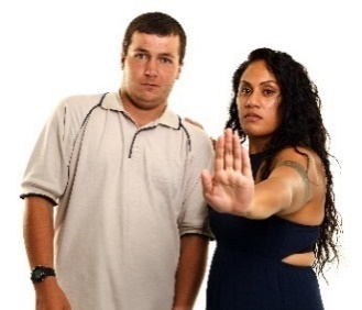 A person with their hand up to protect a participant. The participant looks worried.