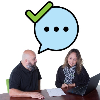 2 people at a table. One has a speech bubble with a tick.