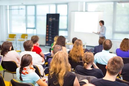 A large group of providers watching someone give a presentation.