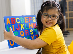 A child with Down syndrome doing a learning activity.