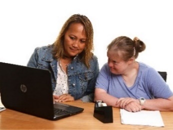 A navigator supporting a participant to access information on a laptop.