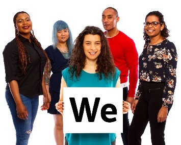 A group of people. The person in front is holding a sign that says 'We'.