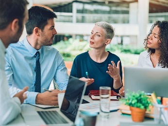 A woman offering advice at a meeting.