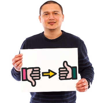 A person holding a sign with thumbs down and an arrow pointing to a  thumbs up