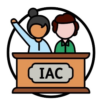 2 new members behind a bench that says 'IAC'.