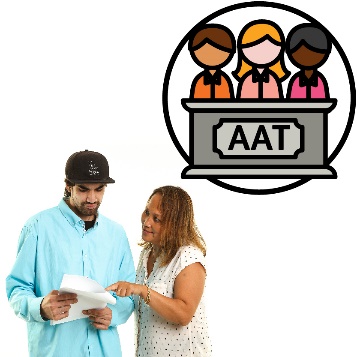 A woman helping a man read a document. Above them is a panel of people behind a podium saying 'AAT'.