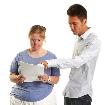 A man helping a woman to read a document. 